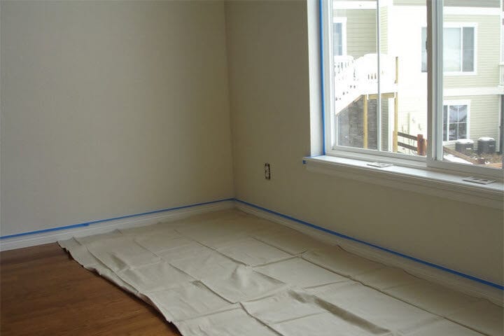 Empty room with drop cloth laid down