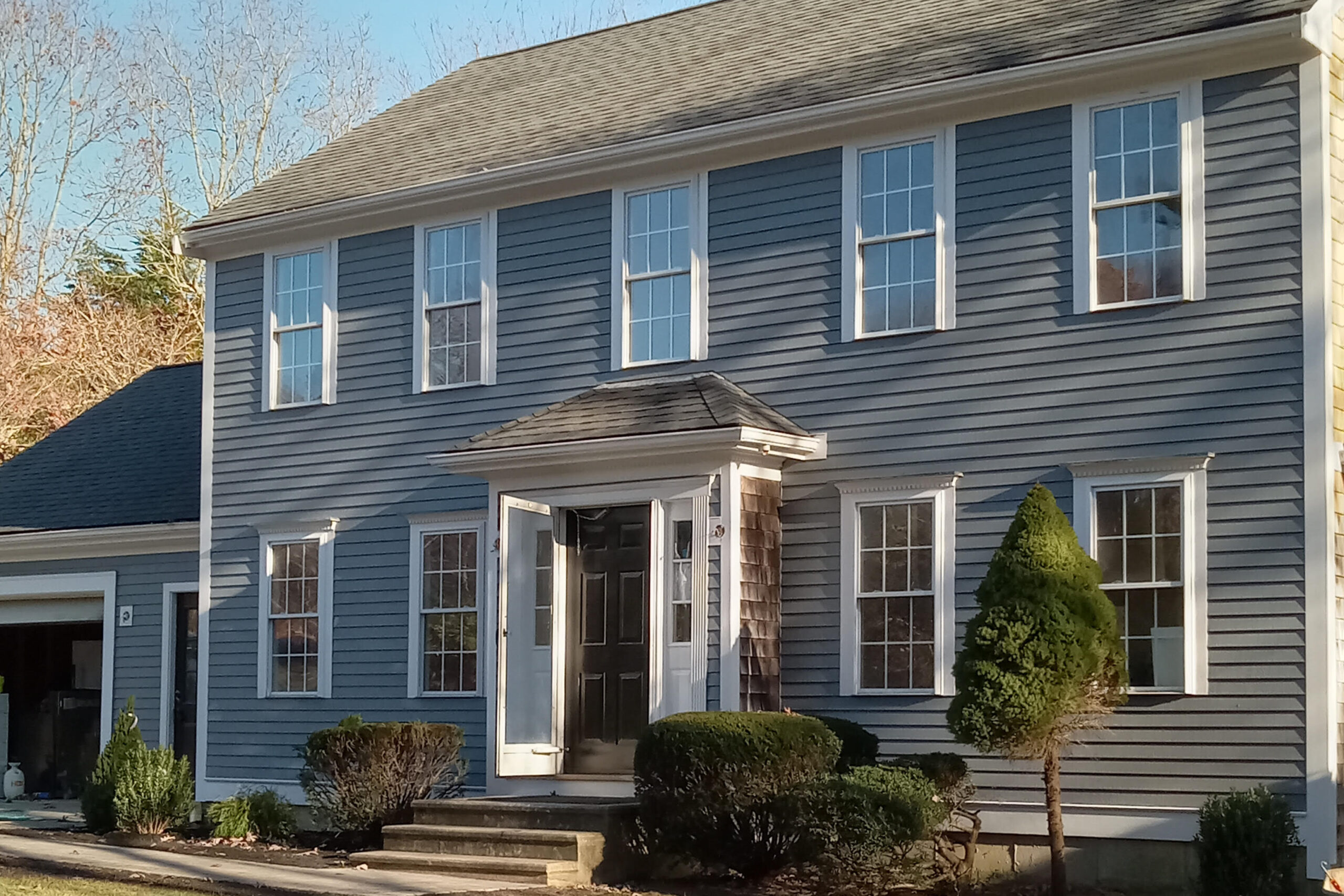 Two-story blue house with porch